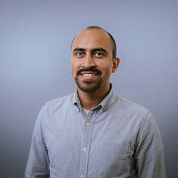 headshot of Isaias Miranda on gray background